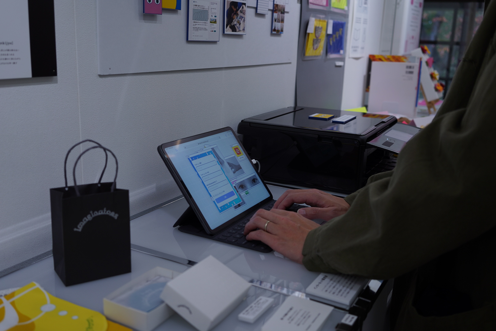 A visitor entering information on the Internet Résumé tablet interface, with the printer beside it